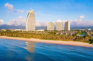 Haitang Bay Sanya sail-shaped hotel tower aerial beach palm trees