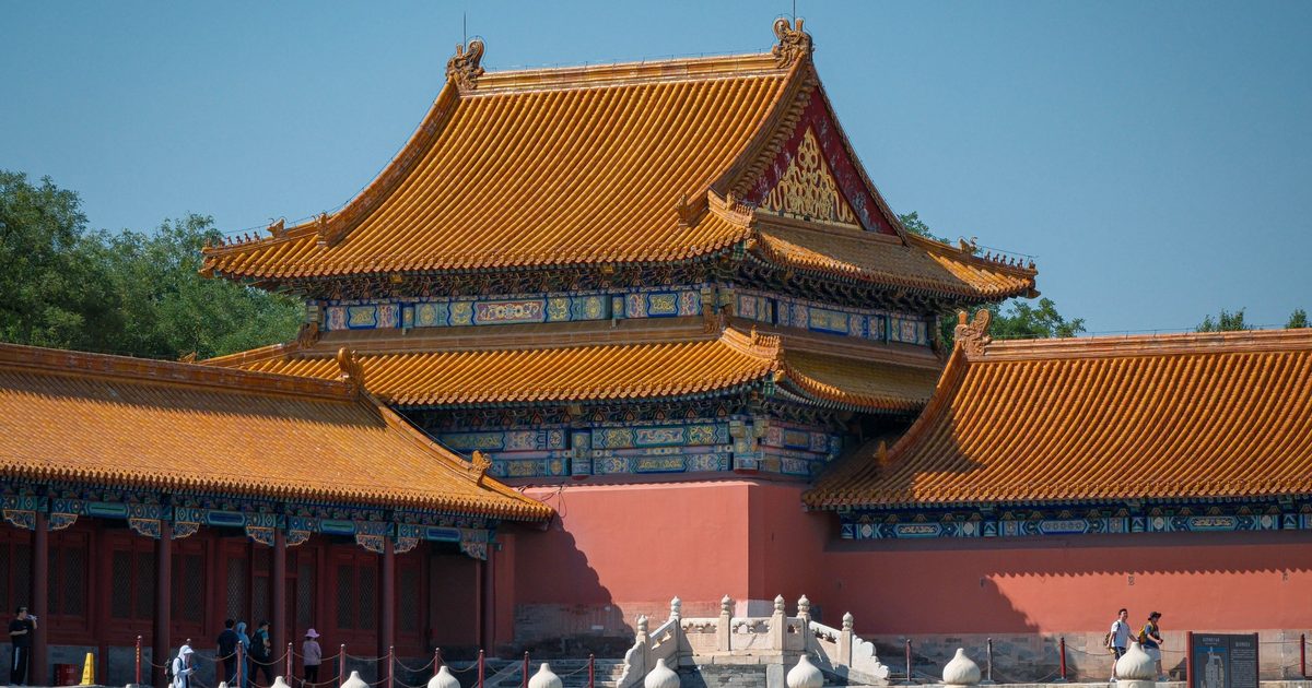Yellow-tiled roofs, red walls and white marble balustrades of a hall in the Forbidden City, Beijing