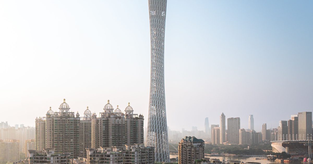 Canton Tower rising above apartment blocks and the Pearl River skyline in Guangzhou, Guangdong Province